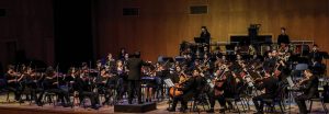 Xena playing violin (center) during the National Conservatory of Music Orchestra Performance at Birzeit University, February 16, 2019.