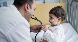 Pediatrician Nader Handal examining a young patient. Photo by Meinrad Schade.