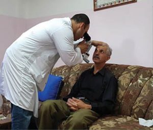 A man is screened for diabetic retinopathy in his own home as part of St John of Jerusalem Eye Hospital Group’s RAAB Study.