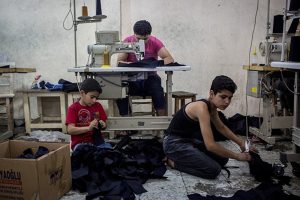 Syrian refugees making jeans in Turkey.