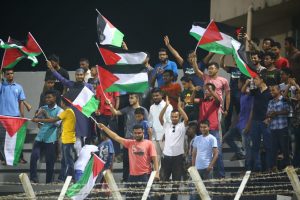 Palestinians cheering their football team.