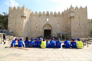 Palestinian students in East Jerusalem schools take a break in front of Damascus Gate after finishing a cleaning day in East Jerusalem Palestinian neighborhoods.