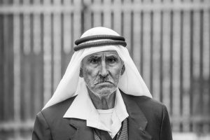 A Palestinian elder stopping to pose for a photo at the Bethlehem Checkpoint while going to work in Jerusalem.