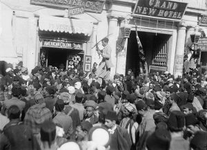 The ceremonial gate of Jerusalem, Jaffa Gate, whence the Caliph Omar – as well as the Kaiser and General Allenby – entered Jerusalem, provided religious and secular spectacles of all peoples and all cultures. The fanfare above depicts the entry of the Hebron contingency to join the other Palestinians in Nabi Musa celebrations. Ottoman banners, Sufi banners, and the American flag stand out.