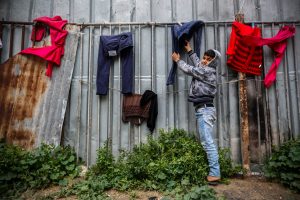 Eleven-year-old Ahmad collecting his family’s clothes before the storm in Jabalia Camp’s Al-Saftawy neighborhood. Photo ©UNICEF-SoP/2019.