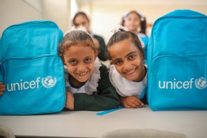 Two Palestinian students receiving back-to-school kits at one of the schools in the Gaza Strip. Photo ©UNICEF-SoP/2019.