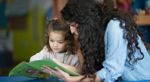 Rana from UNICEF reading a story to a child during a visit to an early childhood development center in Ramallah. Photo ©UNICEF-SoP/2019.